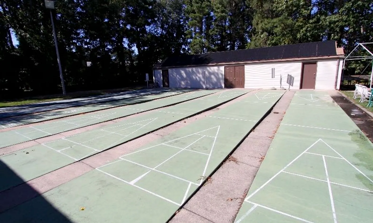 Outdoor shuffleboard courts with shaded canopy